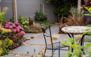 Garden planting with plants in claret and blue colour theme